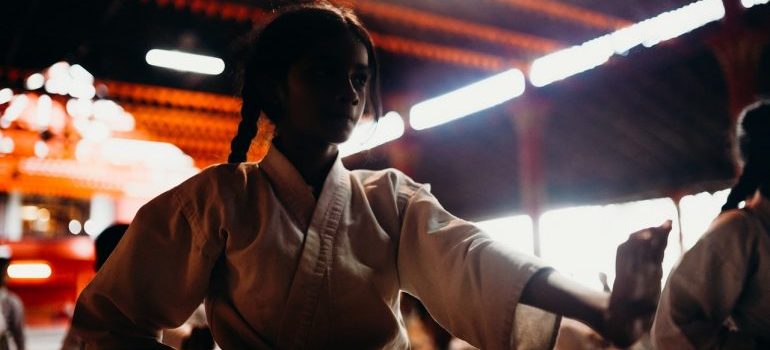 a picture of a girl in a karate class